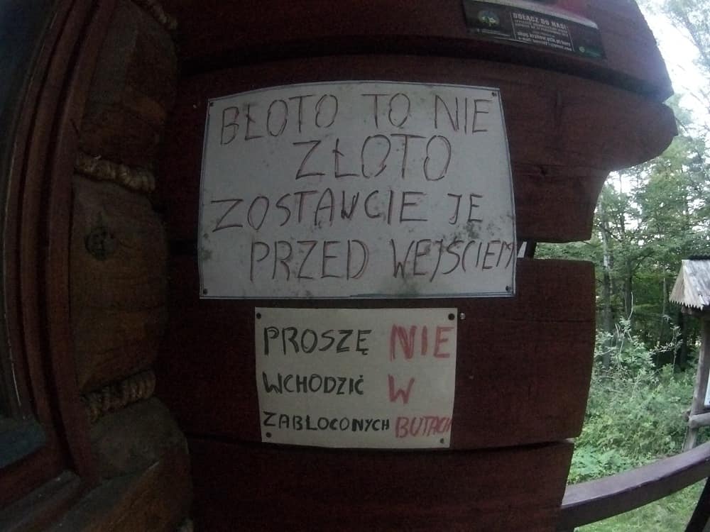 "BŁOTO TO NIE ZŁOTO ZOSTAWCIE JE PRZED DRZWIAMI" napis przy wejściu do schroniska
