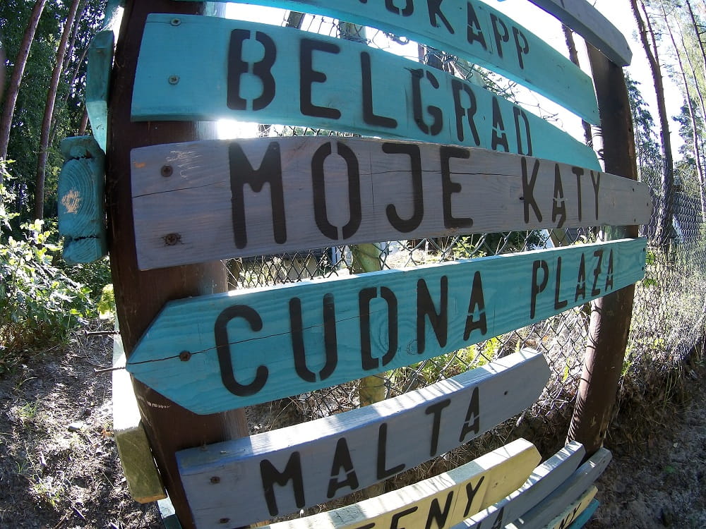 Deskowe drogowskazy, kolejno na: BELGRAD, MOJE KĄTY, CUDNA PLAŻA, MALTA